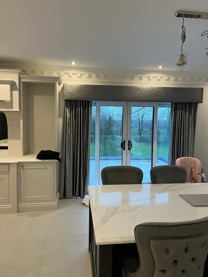 Cream kitchen, navy island and garden doors in the Lowton room